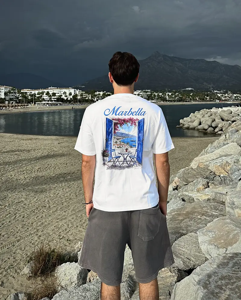 Marbella new window in white, worn, seen from the back on the beach at Puerto Banús