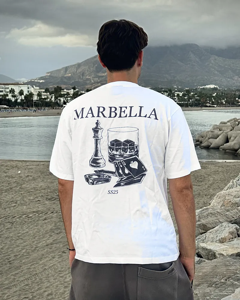 Cards in white, worn, seen from the back on the beach at Puerto Banús