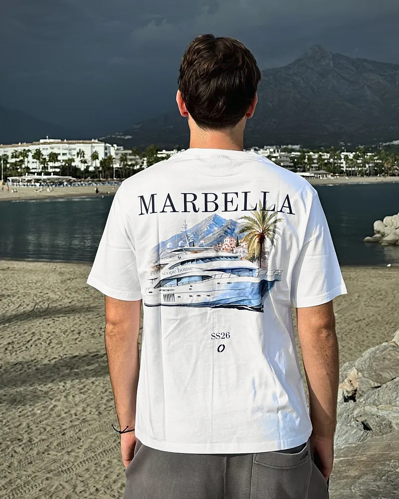 Yacht La Concha in white, worn, seen from the back on the beach at Puerto Banús